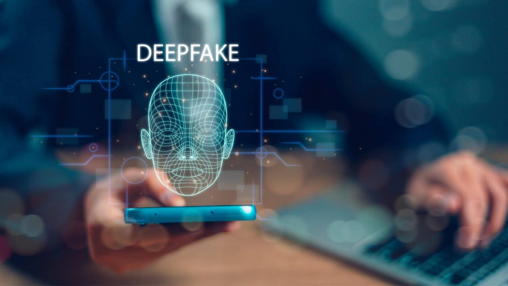 Imagem de um rosto escrito deepfake em cima e saindo de um smartphone