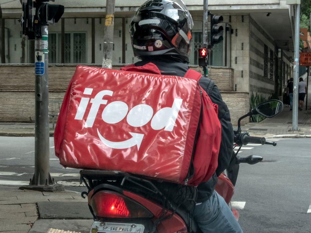 Entregador parceiro do iFood fazendo entregas.