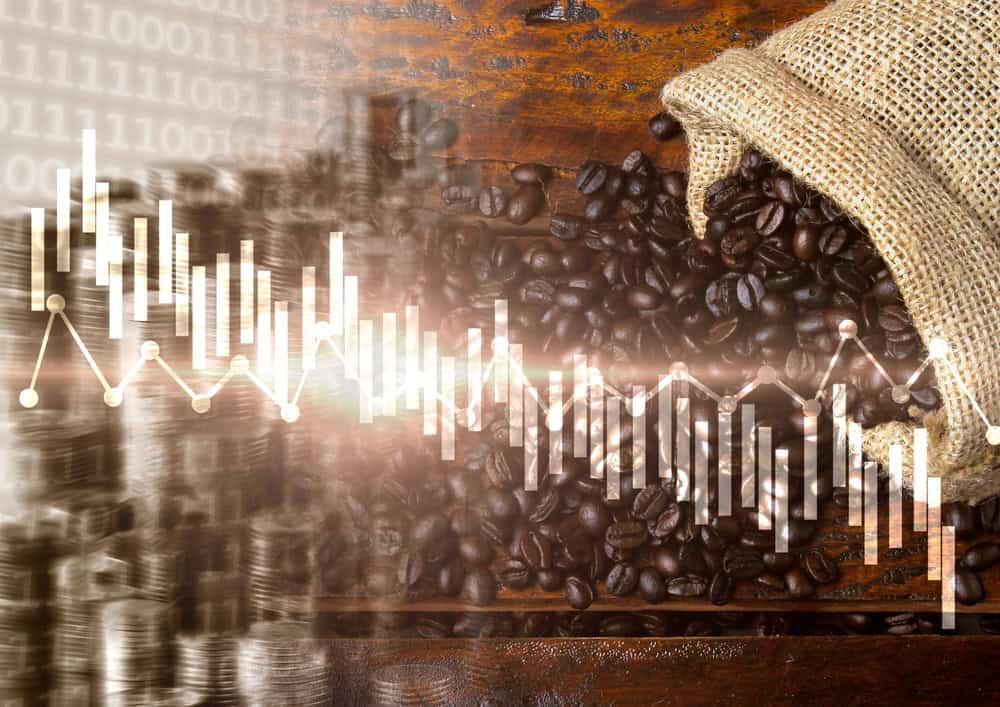 Imagem mostra gráfico de ações em montagem com grãos de café.