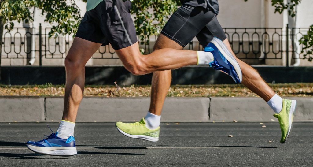 pernas de duas pessoas correndo, fazendo exercícios físicos
