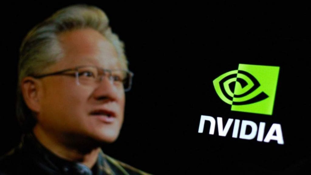 Foto de CEO da Nvidia ao lado de logomarca da empresa
